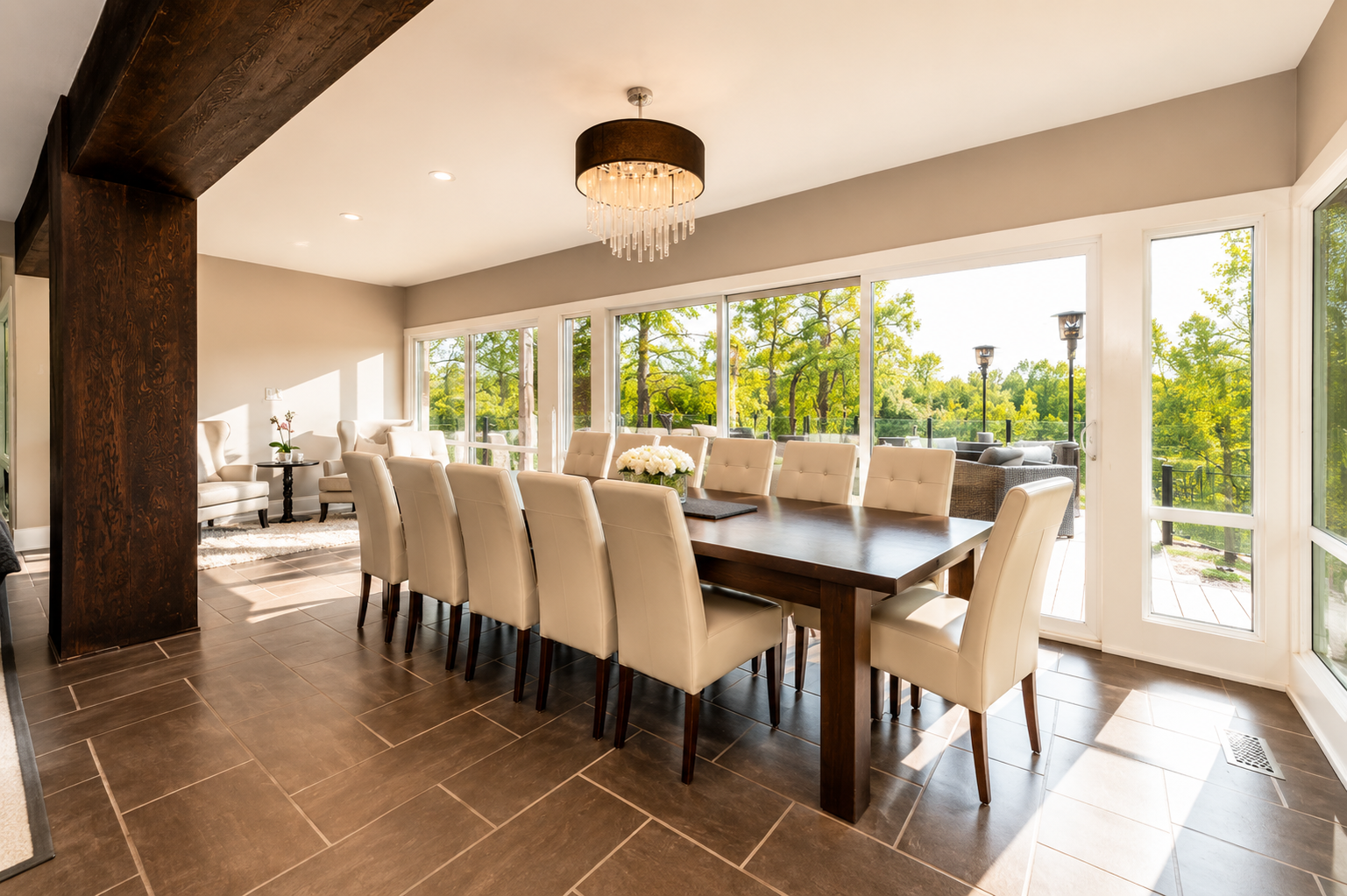 Long dining table for twelve beside windows onto the deck