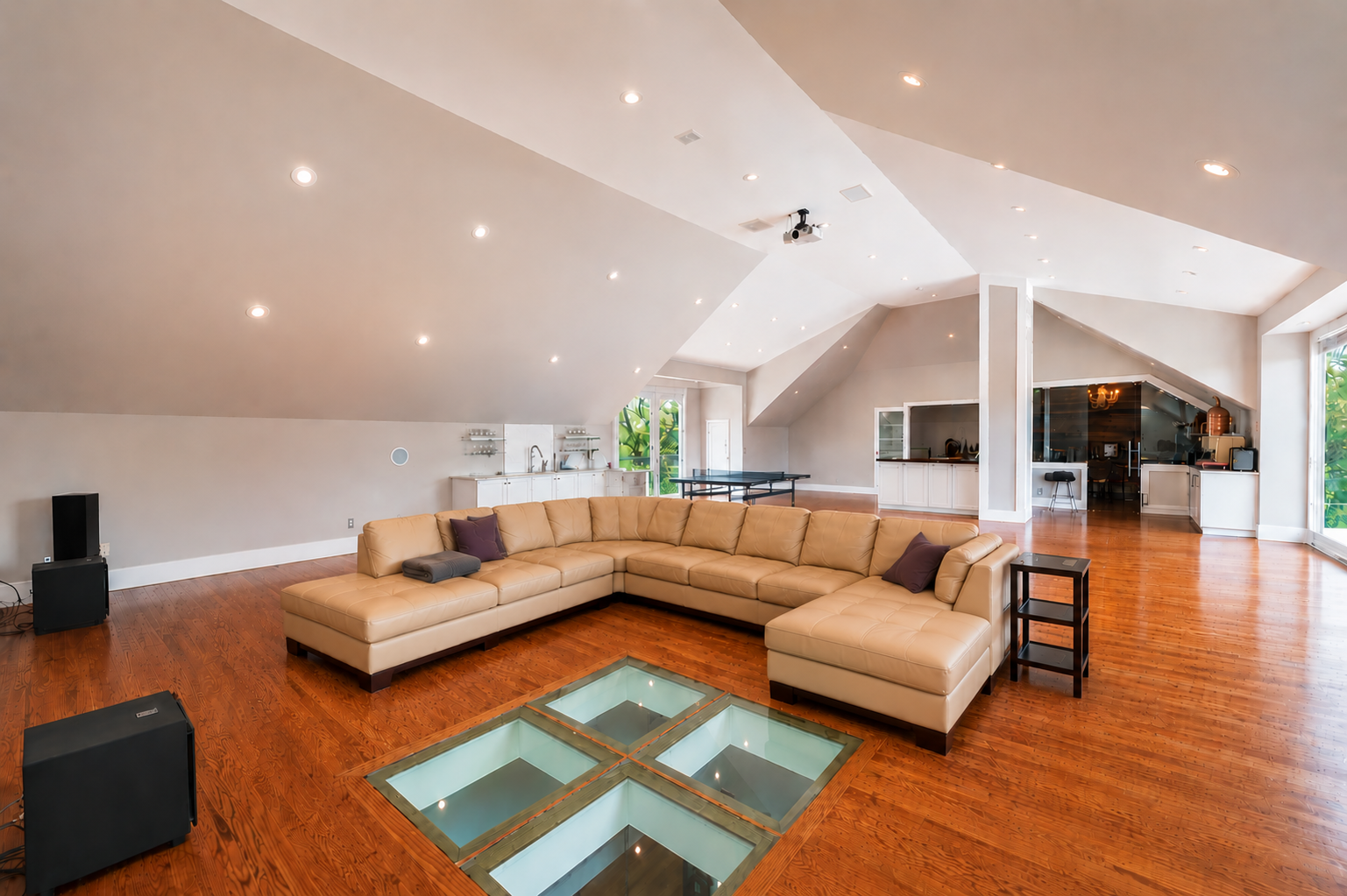 Vaulted loft with projection theatre seating, table tennis and bar